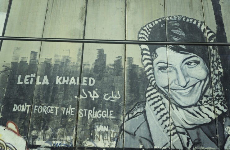 Mural with Leila Khaled, veteran and leading member of the PFLP, somewhere along the apartheidwall. Photo: Boris Kasimow. (CC BY 2.0).